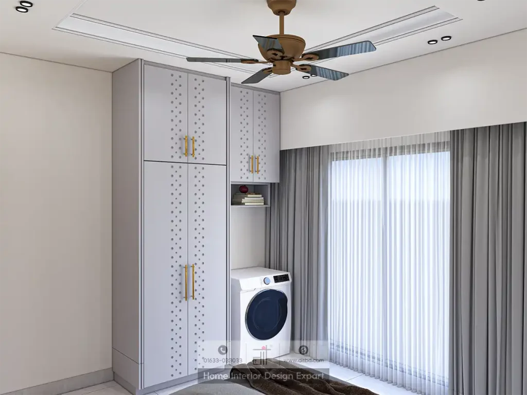 Bedroom corner featuring tall white wardrobe with perforated panels, built-in washing machine, open shelves, and large window with sheer and grey layered curtains.
