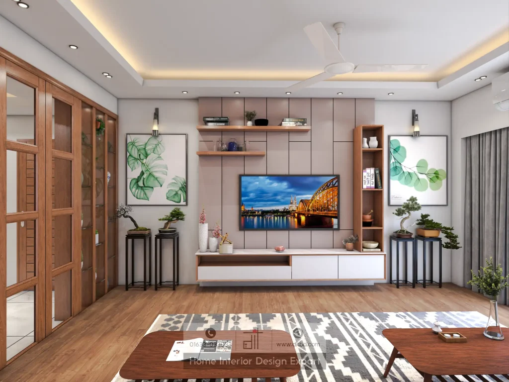 Full TV wall view with monstera and eucalyptus framed prints, bonsai plants, and geometric rug in family living room by DIT Studio