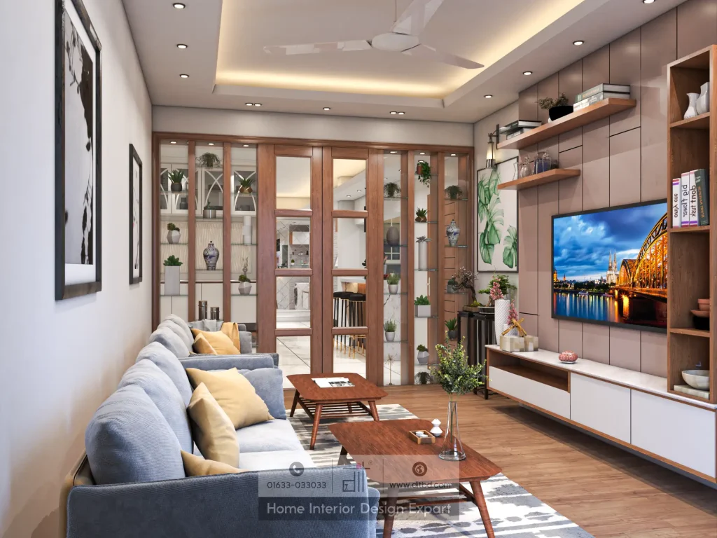Family living room with blue-grey sectional sofa, walnut coffee tables, and beige TV wall with open bookcase by DIT Studio Bangladesh