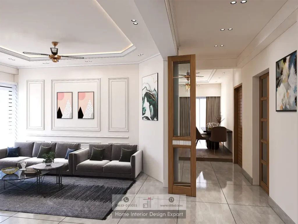 Living room with grey L-shaped sofa, wall mouldings and geometric art prints in Basila common area designed by DIT Studio