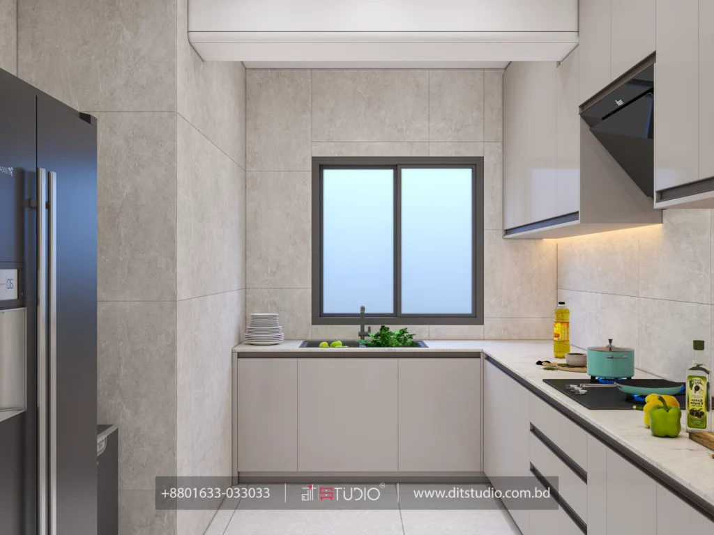 Kitchen sink under a window with L shaped grey counters and a stainless refrigerator
